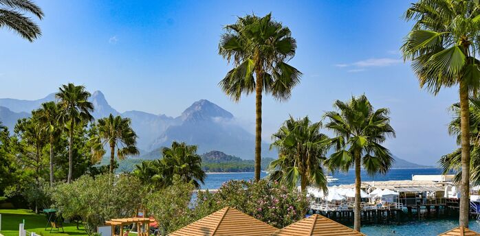 Palm-lined Mediterranean resort with mountain views