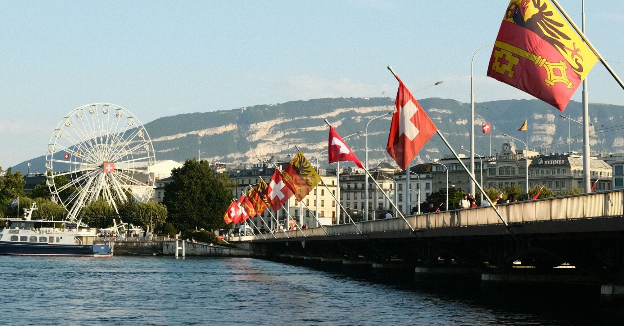 Geneva waterfront with Swiss flags
