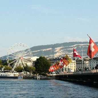 Geneva waterfront with Swiss flags