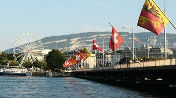Geneva waterfront with Swiss flags