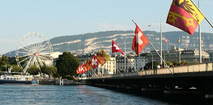 Geneva waterfront with Swiss flags