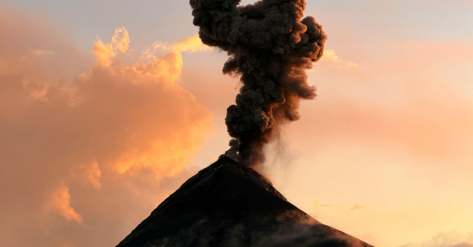 Volcanic ash plume rising from a volcano