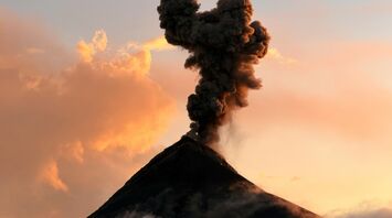 Volcanic ash plume rising from a volcano