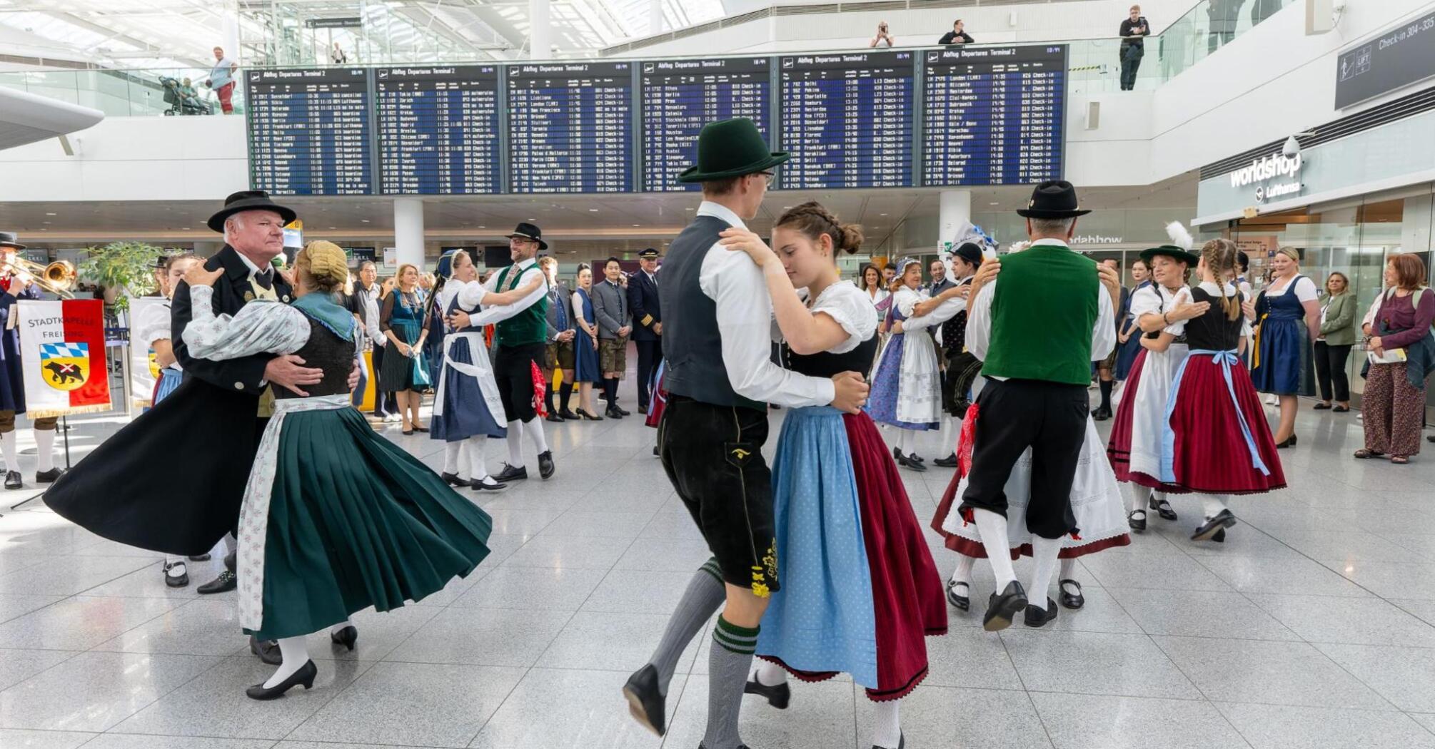 Traditional Bavarian dancers performing inside Munich Airport