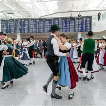 Traditional Bavarian dancers performing inside Munich Airport