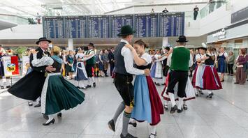 Traditional Bavarian dancers performing inside Munich Airport