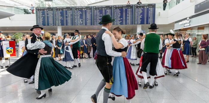 Traditional Bavarian dancers performing inside Munich Airport